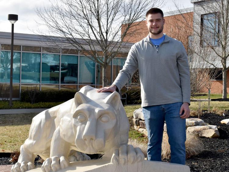 Dylan Treaster with the Lion Shrine on the campus of Penn State DuBois